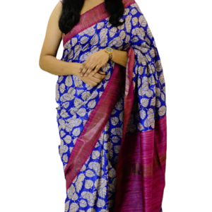 Royal blue and magenta silk saree with intricate golden leaf motifs, elegantly draped by a woman, exuding timeless charm and sophistication